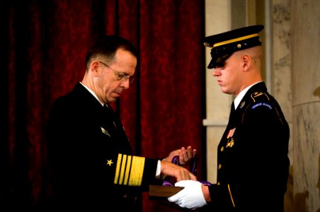 US Navy 071029-N-0696M-121 Chairman of the Joint Chiefs of Staff, Adm. Mike Mullen prepares to present the Gold Medal of Remembrance to the children of five service members photo