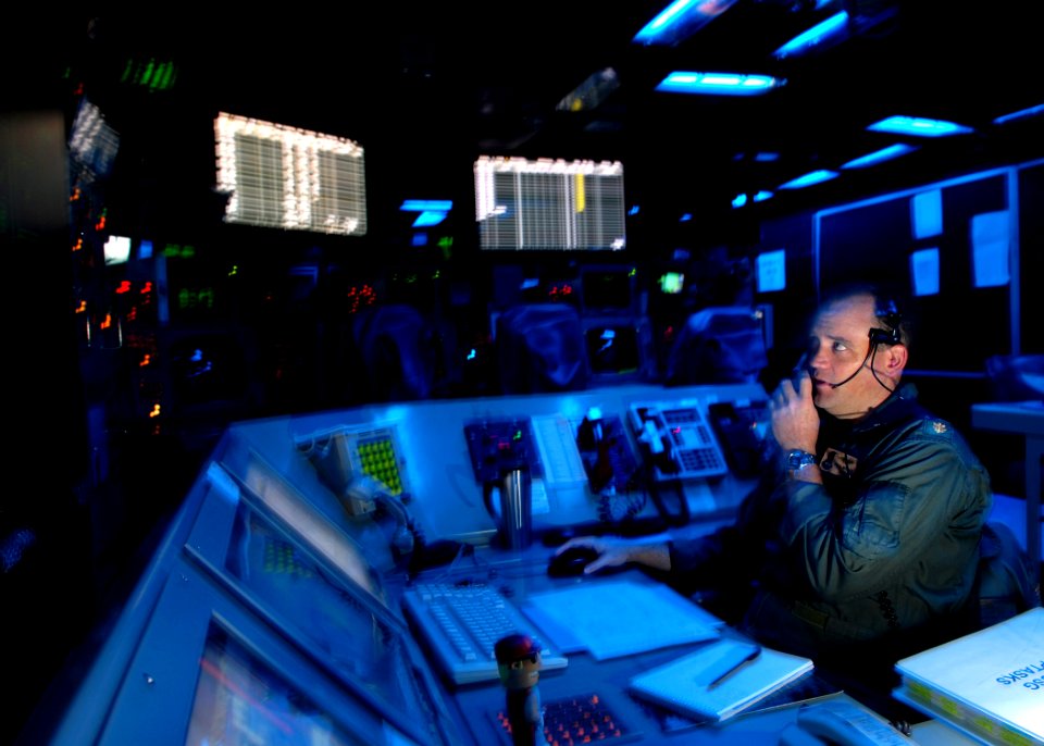 US Navy 071027-N-7981E-045 Lt. Cmdr. Paul Kesler acts as Tactical Action inside the combat direction center aboard Nimitz-class aircraft carrier USS Abraham Lincoln (CVN 72) photo