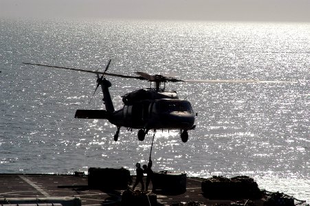 US Navy 071031-N-7955L-108 An MH-60S Seahawk assigned to Helicopter Combat Sea Squadron (HSC) 26, picks up pallets from fast combat support ship USNS Supply (T-AOE 6) photo