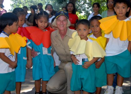 US Navy 071030-N-6710M-042 Rear Adm. Carol Pottenger, commander, Combined Task Force (CTF) 76, poses for a picture with students at New Cabalan Elementary School