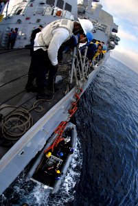 US Navy 071105-N-7981E-205 Sailors aboard Arleigh Burke-class guided-missile destroyer USS Shoup (DDG 86) ready a ladder for a personnel transfer from USS Momson (DDG 92) via rigid hull inflatable boat photo