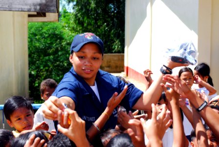 US Navy 071030-N-0120A-147 Storekeeper Seaman Megan Antunes, passes out small gifts to students from the Iram School
