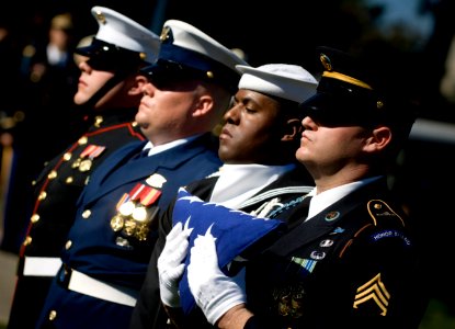 US Navy 071031-N-0696M-295 The joint service honor guard prepares to present the national ensign during the funeral services for Adm. William J. Crowe, the 11th Chairman of the Joint Chiefs of Staff, who died Oct. 18 at the age