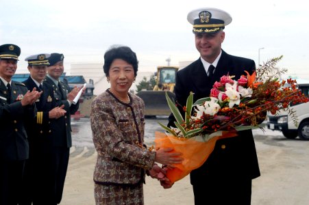 US Navy 071101-N-9123L-004 Cmdr. John S. Banigan, commanding officer of guided-missile destroyer USS John S. McCain (DDG 56), accepts flowers from the Sendai Welcoming Delegation