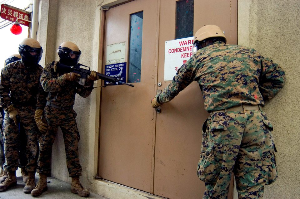 US Navy 071106-N-5253W-002 Marines assigned to the 1st Fleet Anti-terrorism Security Team (FAST), 3rd Platoon prepare to enter a building during advanced urban combat training on board Commander Fleet Activities Yokosuka