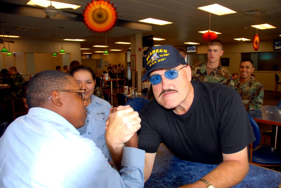 US Navy 071102-N-2468S-001 Professional wrestling champion Sgt. Slaughter arm-wrestles with Builder Constructionman Recruit Lars Triggs