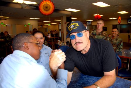 US Navy 071102-N-2468S-001 Professional wrestling champion Sgt. Slaughter arm-wrestles with Builder Constructionman Recruit Lars Triggs