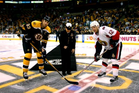 US Navy 071104-N-8110K-003 Command Master Chief Sandra Huffman, assigned to the guided-missile destroyer USS Sampson (DDG 102), drops the ceremonial first puck