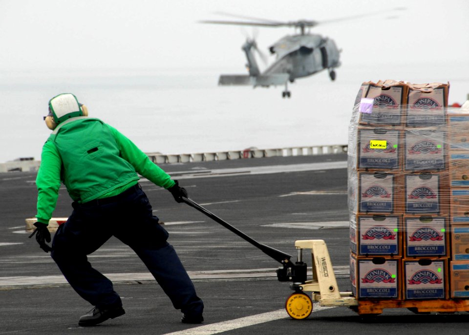 US Navy 071103-N-7981E-139 A Sailor uses a pallet jack to move newly received food stores to an aircraft elevator aboard Nimitz-class aircraft carrier USS Abraham Lincoln (CVN 72) during a vertical replenishment with USNS Henry