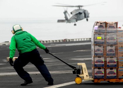 US Navy 071103-N-7981E-139 A Sailor uses a pallet jack to move newly received food stores to an aircraft elevator aboard Nimitz-class aircraft carrier USS Abraham Lincoln (CVN 72) during a vertical replenishment with USNS Henry