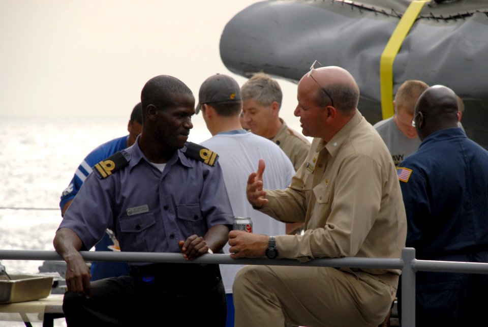 US Navy 071104-N-0193M-104 Lt. A.S. Omotosho, a Nigerian navy officer embarked with Africa Partnership Station (APS), talks with Cmdr. Martin Pompeo, commanding officer of USS Fort McHenry (LSD 43), during a steel beach picnic