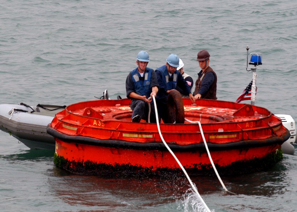 US Navy 071107-N-0807W-042 Sailors attached to the mine warfare ship USS Patriot (MCM 7), work together to moor the ship to a buoy in waters just off the coast of Hong Kong, for a scheduled port visit
