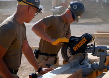 US Navy 071101-N-3857R-002 Builder Constructionman Recruit Adam Moenkedick, assigned to Naval Mobile Construction Battalion (NMCB) 1, cuts a piece of wood to be used in construction of a crow's nest watch station