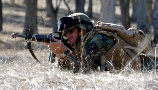 US Navy 071106-N-0775Y-079 Lt. Jeff Bartlett returns enemy fire after his squad was ambushed while conducting a patrol during an officer's field training exercise on board Fort Hunter Liggett