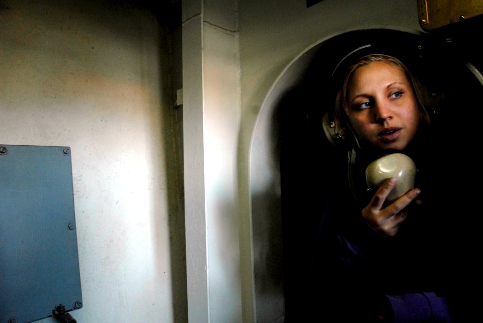 US Navy 071105-N-4776G-279 Aviation Boatswain's Mate (Fuel) Airman Amber Punkwitz uses a sound powered telephone during a refueling at sea aboard Nimitz-class aircraft carrier USS Ronald Reagan (CVN 76)