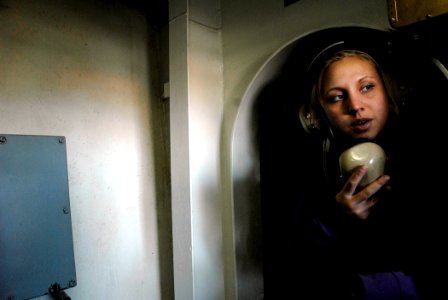 US Navy 071105-N-4776G-279 Aviation Boatswain's Mate (Fuel) Airman Amber Punkwitz uses a sound powered telephone during a refueling at sea aboard Nimitz-class aircraft carrier USS Ronald Reagan (CVN 76)