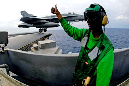 US Navy 071109-N-7883G-020 Aviation Boatswain's Mate (Equipment) Airman Thomas Burress stands the bow safety watch during flight operations aboard aircraft carrier USS Kitty Hawk (CV 63) photo