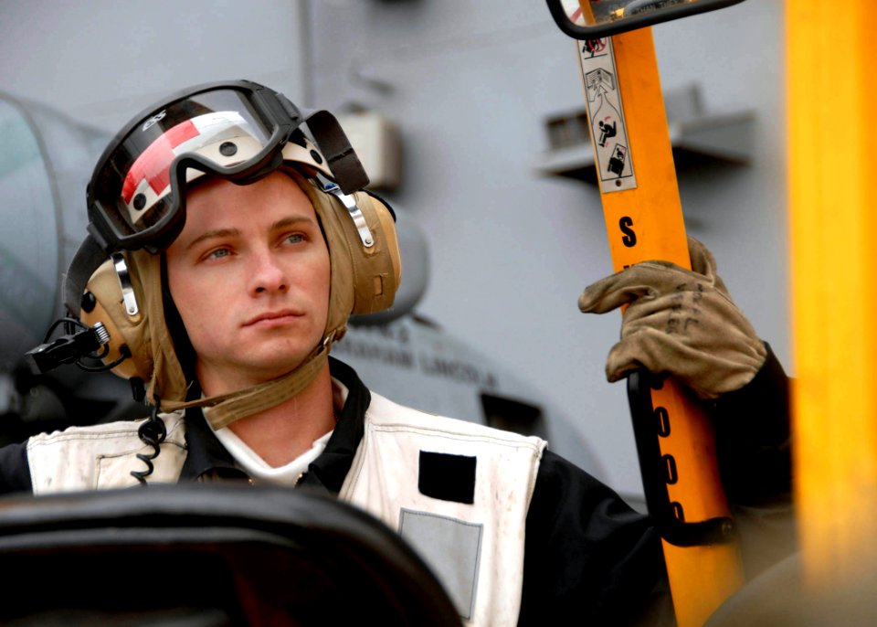US Navy 071103-N-7981E-173 Seaman Steven Wilson, assigned to the medical department, acts as a standby corpsman in case of a medical emergency during a vertical replenishment between Nimitz-class aircraft carrier USS Abraham Li