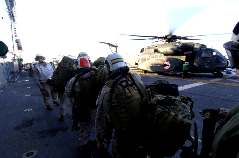 US Navy 071104-N-7027P-051 Prior to flying ashore during a crisis response exercise, Chief Warrant Officer Bryan Simon ensures Marines attached to 4th Platoon 2nd Fleet Anti-terrorism Security Team (FAST) cross the flight deck