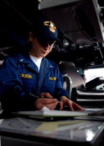 US Navy 071106-N-7981E-075 Lt. j.g. Elizabeth Erickson records course changes while acting as conning officer on the bridge of guided-missile destroyer USS Shoup (DDG 86)