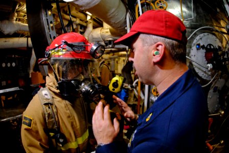 US Navy 071110-N-7883G-040 Chief Machinery Repairman Tim Groeneveld, right, gives instructions to Damage Controlman 3rd Class Jonathan Rios during a main machinery space fire drill aboard the aircraft carrier USS Kitty Hawk (CV