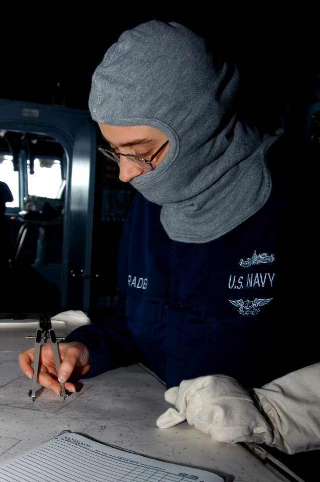 US Navy 071106-N-7955L-016 Quartermaster 1st Class Susan Rader plots on a chart during a general quarters drill aboard the amphibious assault ship USS Kearsarge (LHD 3)