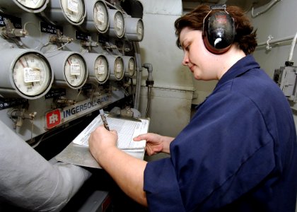 US Navy 071106-N-8132M-027 Machinist's Mate 1st Class Karin Thomas takes high-pressure air compressor readings inside the O2N2 lab aboard nuclear-powered aircraft carrier USS Enterprise (CVN 65)