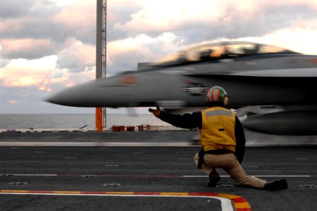 US Navy 071107-N-0455L-011 A flight deck shooter launches an F-A-18 Hornet from the flight deck aboard USS Harry S. Truman (CVN 75)