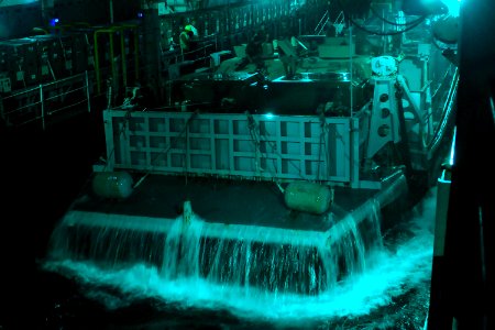 US Navy 071105-N-6597H-065 Water pours off a landing craft utility as it pulls into the well deck of the amphibious assault ship USS Tarawa (LHA 1)