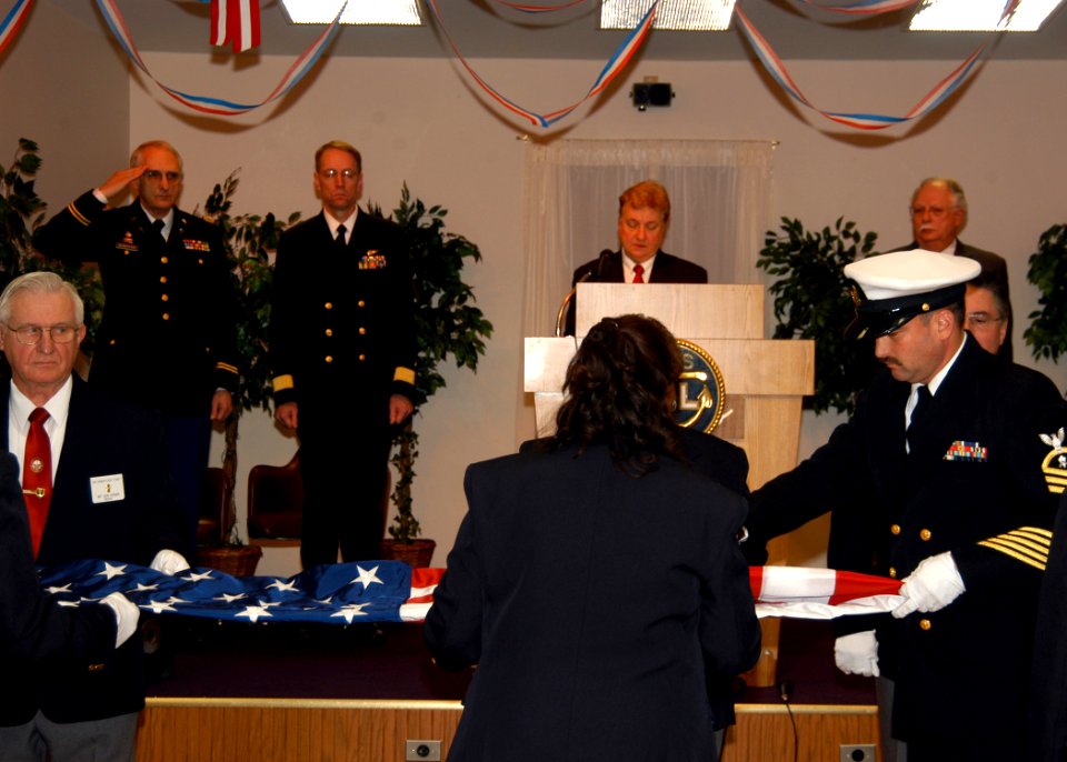 US Navy 071110-N-9860Y-004 Chief Builder Marc deLeuze and members of the Oak Harbor Elks Lodge perform a ceremonial flag folding at the Oak Harbor Veterans Day ceremony