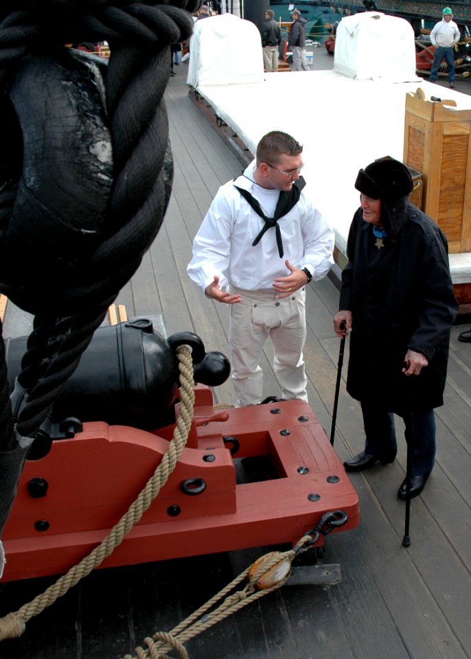 US Navy 071108-N-2893B-002 Boatswain's Mate 1st Class Aaron Haney gives a tour of USS Constitution to Medal of Honor recipient retired Navy Lt. John Finn. At 98 years old, Finn is the oldest living Medal of Honor recipient