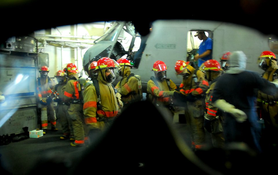 US Navy 071109-N-4774B-054 Sailors don firefighting ensembles during a general quarters drill aboard the amphibious assault ship USS Tarawa (LHA 1)