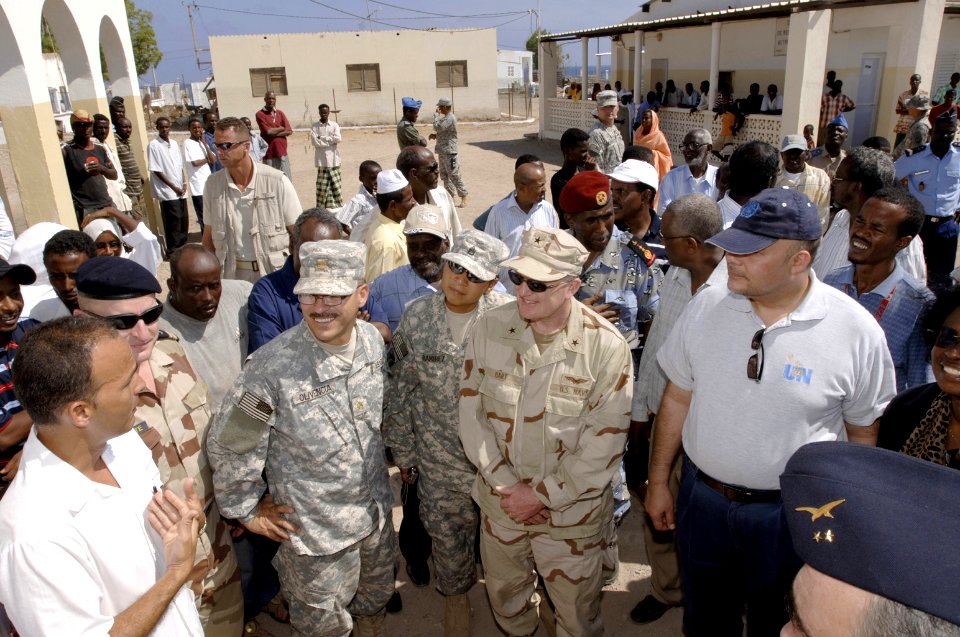 US Navy 071112-F-0509T-148 Dr. Leonardo Cangronis speaks to Rear Adm. James Hart, commander of Combined Joint Task Force-Horn of Africa (CJTF-HOA), and other dignitaries during a visit to a medical clinic in Obock