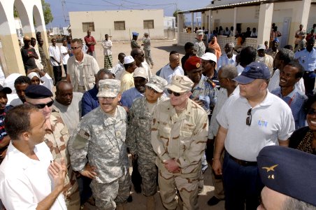 US Navy 071112-F-0509T-148 Dr. Leonardo Cangronis speaks to Rear Adm. James Hart, commander of Combined Joint Task Force-Horn of Africa (CJTF-HOA), and other dignitaries during a visit to a medical clinic in Obock photo