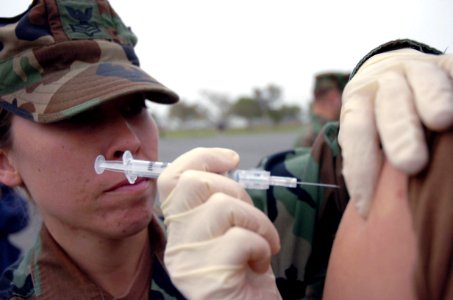 US Navy 071107-N-0775Y-008 Hospital Corpsman 1st Class Elizabeth Gonzalez administers a typhoid shot to a Seabee during a battalion-wide immunization day at Port Hueneme