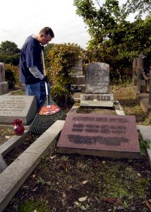 US Navy 071107-N-4649C-003 Chief Operations Specialist Jay Langford, stationed on board Afloat Training Group Western Pacific (ATGWP), rakes up dead leaves at the Yamate Gaijin Bochi Cemetery in Yokohama, Japan