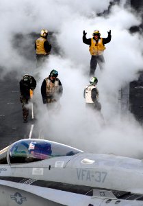 US Navy 071107-N-0455L-006 A plane director gives directional signaling to an F-A-18E Super Hornet in preparation for launch from Nimitz-class aircraft carrier USS Harry S. Truman (CVN 75)