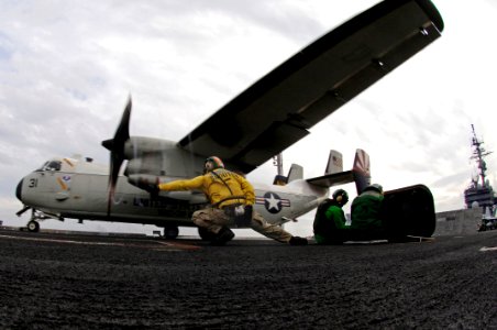 US Navy 071109-N-7883G-005 An aircraft shooter gives the final signal to launch a C-2A Greyhound, assigned to Fleet Logistics Support Squadron (VRC) 30, from aboard aircraft carrier USS Kitty Hawk (CV 63)