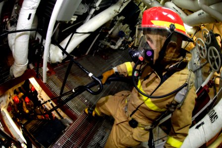 US Navy 071110-N-7883G-096 Damage Controlman Fireman Vernon Snodgrass, 21, of Gary, Ind., helps fellow hose team members up a ladder during a main machinery space fire drill in the No. 2 main machinery room aboard USS Kitty Haw