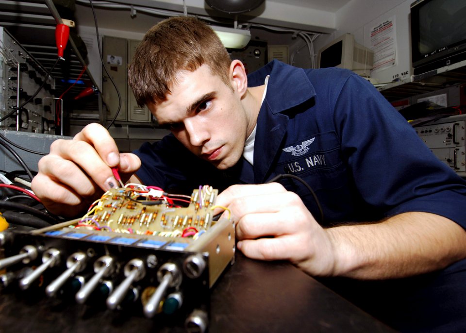 US Navy 071106-N-8132M-026 Aviation Electronics Technician Airman Gregory Hardin troubleshoots an aviation inter-phone communicator using a multimeter aboard nuclear-powered aircraft carrier USS Enterprise (CVN 65)