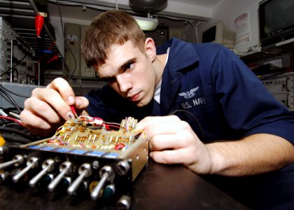 US Navy 071106-N-8132M-026 Aviation Electronics Technician Airman Gregory Hardin troubleshoots an aviation inter-phone communicator using a multimeter aboard nuclear-powered aircraft carrier USS Enterprise (CVN 65)