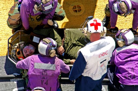 US Navy 071109-N-6597H-306 Aviation boatswain's mates prepare to transport a simulated causality to the medical department aboard amphibious assault ship USS Tarawa (LHA 1) during firefighting training