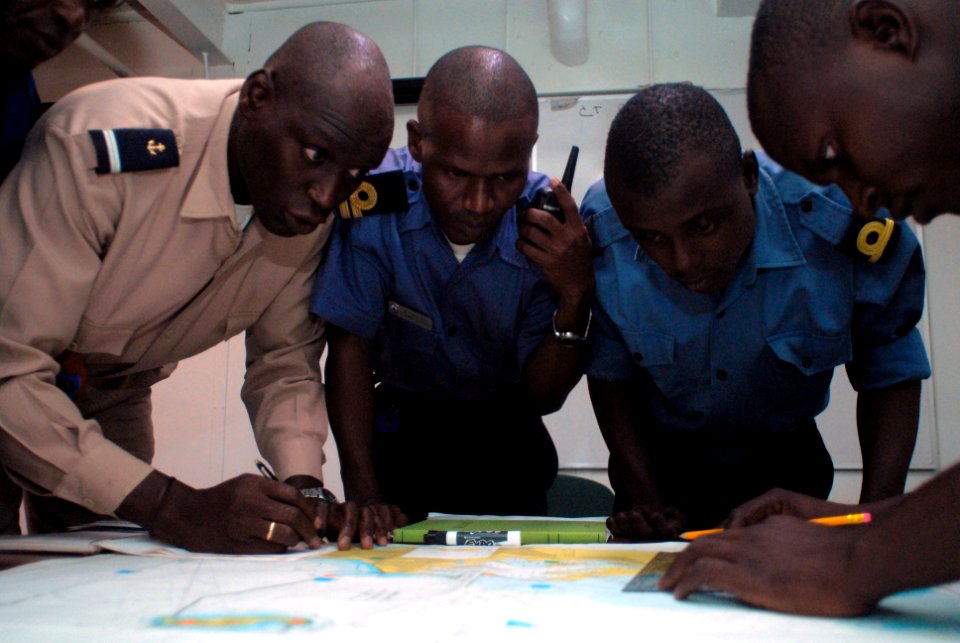 US Navy 071112-N-0193M-082 Military members from Senegal, Ghana and Nigeria work together to plot out small boat movements during a training exercise lead by the U.S. Coast Guard International Training Division aboard amphibiou