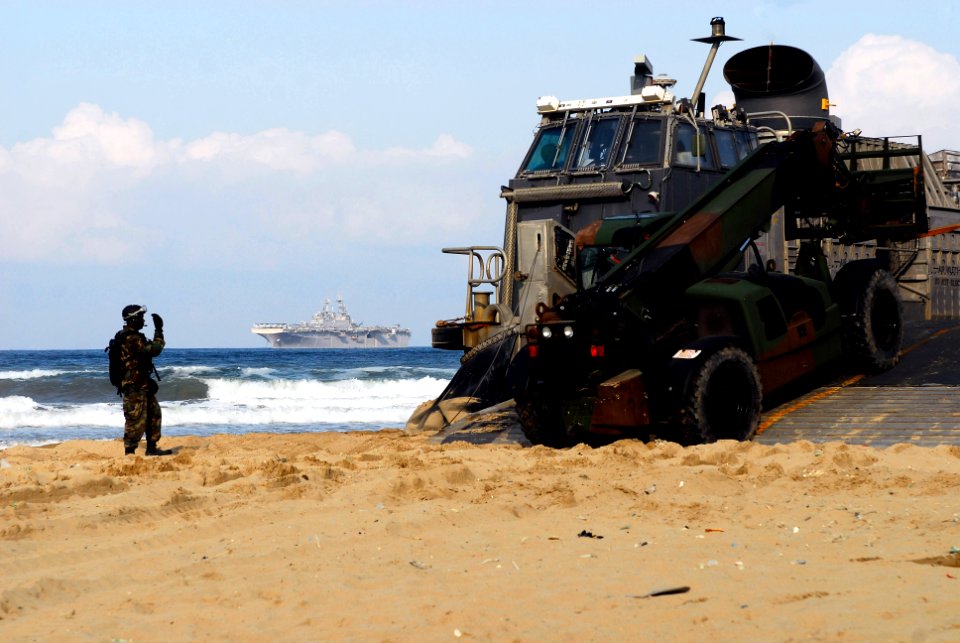 US Navy 071111-N-0120A-158 Seaman Chris Smith, assigned to Beach Master Unit (BMU) 1, directs the loading of Marine equipment and supplies onto Landing Craft Air Cushion (LCAC) 90 on the beach