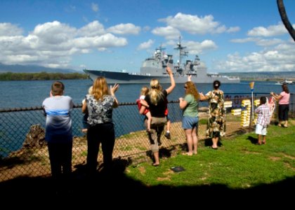 US Navy 071112-N-6674H-009 Family and friends wave farewell to Sailors aboard guided-missile cruiser USS Port Royal (CG 73) as she departs Naval Station Pearl Harbor for deployment