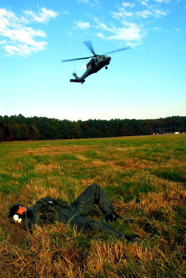 US Navy 071114-N-8704K-075 Aviation Warfare Systems Operator 3rd Class Elias Diaz-Kincaid, assigned to Helicopter Sea Combat Squadron (HSC) 26, awaits retrieval from a MH-60S Seahawk helicopter