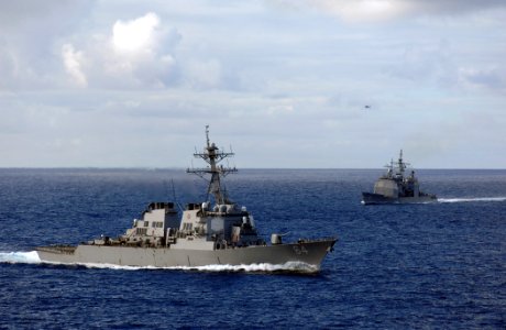 US Navy 071112-N-8923M-016 Guided-missile destroyer USS Carney (DDG 64) and guided-missile cruiser USS Hue City (CG 66) guide into position aft of Nimitz-class aircraft carrier USS Harry S. Truman (CVN 75) during a maneuvering