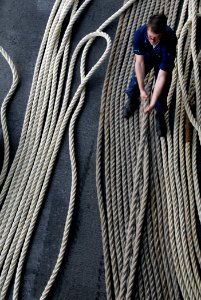 US Navy 071117-N-7981E-054 Seaman Richard Burton, assigned to Deck Department, fakes down mooring lines on the fantail aboard the Nimitz-class nuclear-powered aircraft carrier USS Abraham Lincoln (CVN 72), after getting underwa photo