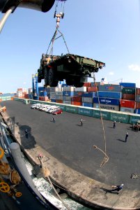 US Navy 071118-N-0193M-829 Members of deck department use a crane to move vehicles and equipment off of the amphibious dock landing ship USS Fort McHenry (LSD 43)