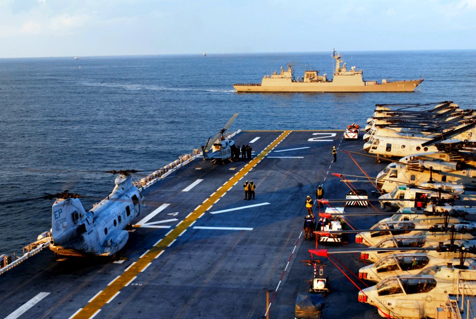 US Navy 071111-N-4010S-168 The Korean guided-missile destroyer Moonmu Deawang (DDG 976) passes in front of the bow of the amphibious assault ship USS Essex (LHD 2)